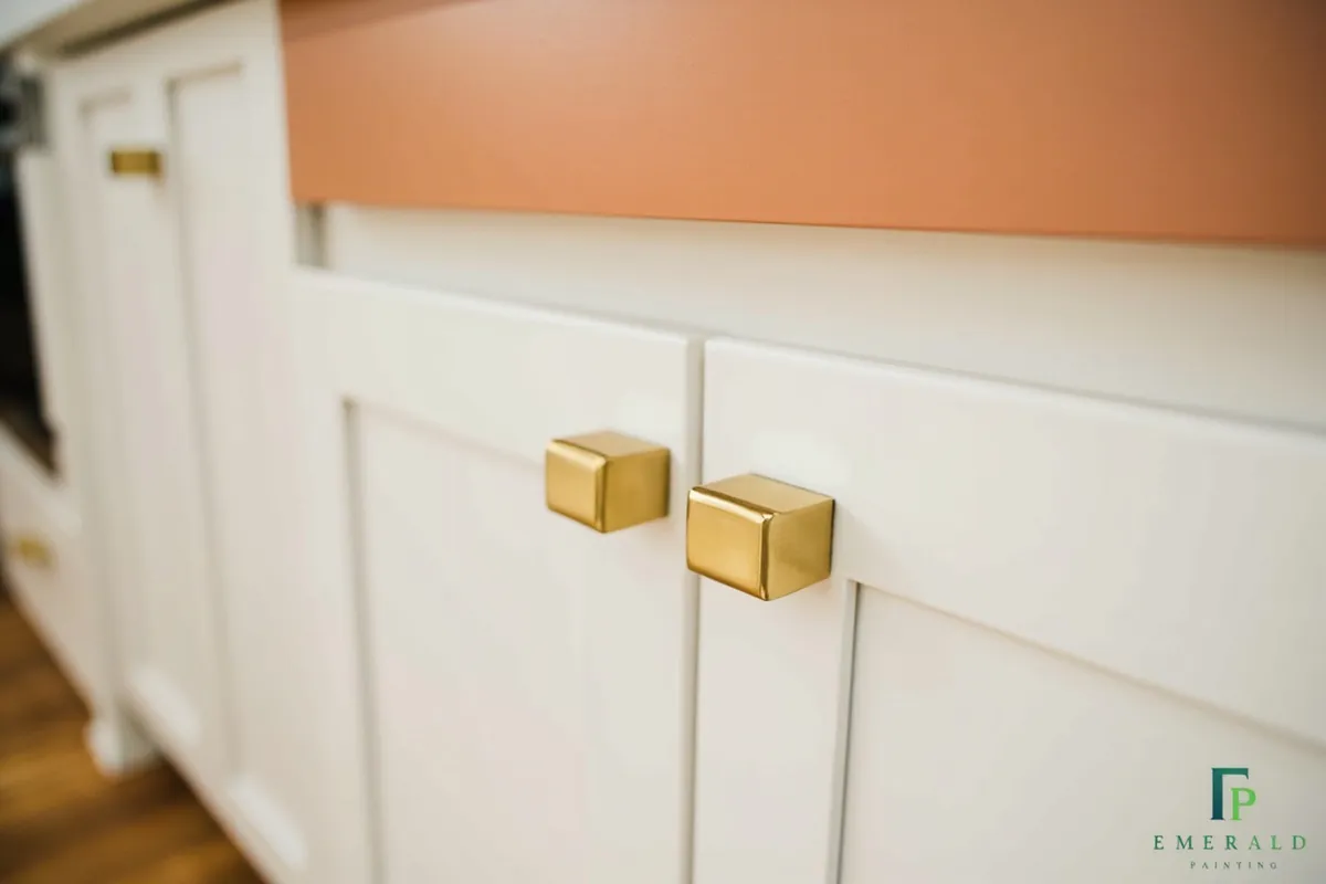 Refinished white kitchen cabinets with modern hardware